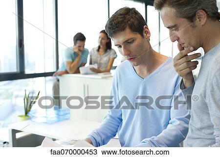 Colleagues working together in office View Large Photo Image Stock Image - Colleagues working together in office. Fotosearch