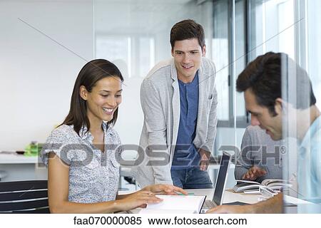 Colleagues working together in office View Large Photo Image Stock Photography - Colleagues working together in office. Fotosearch
