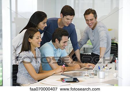 Colleagues working together with laptop computer View Large Photo Image Stock Photo - Colleagues working together with laptop computer. Fotosearch