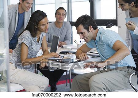 Colleagues working with digital tablet in office View Large Photo Image Stock Image - Colleagues working with digital tablet in office. Fotosearch