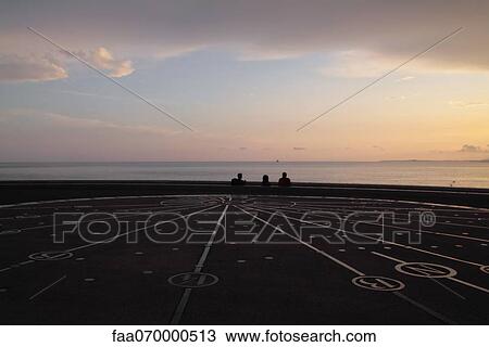 Compass rose, people looking at sunset in background View Large Photo Image Stock Image - Compass rose, people looking at sunset in background. Fotosearch