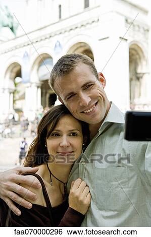 Couple posing for picture outdoors View Large Photo Image Stock Photograph - Couple posing for picture outdoors. Fotosearch