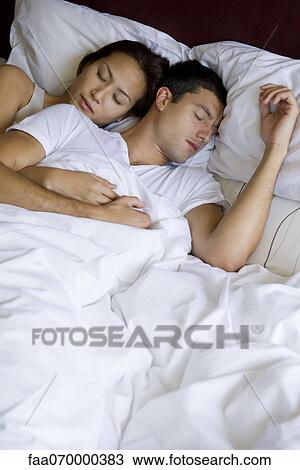Couple sleeping together in bed View Large Photo Image Stock Image - Couple sleeping together in bed. Fotosearch