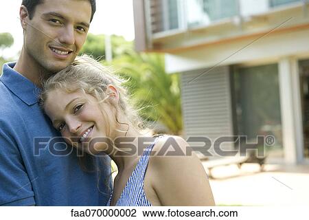 Couple together in front of home, portrait View Large Photo Image Stock Image - Couple together in front of home, portrait. Fotosearch