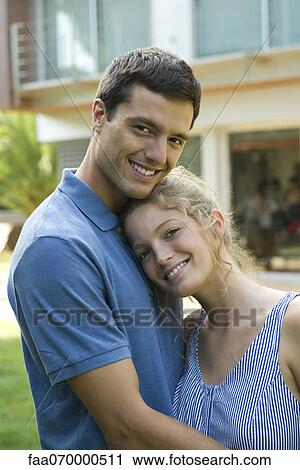 Stock Image - Couple together outdoors, portrait. Fotosearch