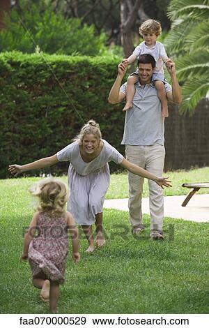 Stock Photo - Family having fun outdoors. Fotosearch