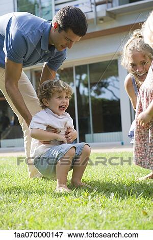 Family having fun together outdoors View Large Photo Image Stock Photo - Family having fun together outdoors. Fotosearch