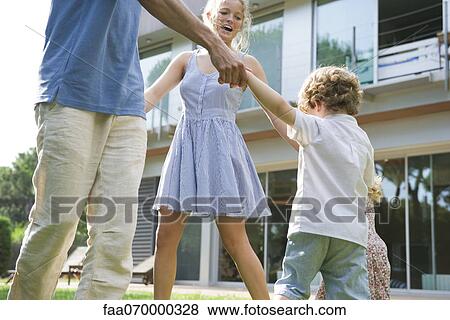 Family playing ring-around-the-rosy outdoors View Large Photo Image Stock Photo - Family playing ring-around-the-rosy outdoors. Fotosearch