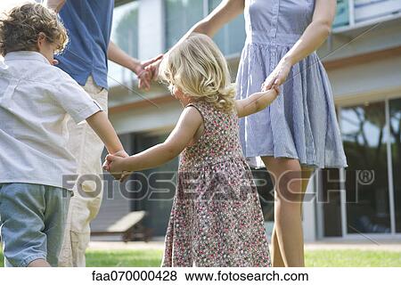Family playing ring-around-the-rosy outdoors View Large Photo Image Stock Photo - Family playing ring-around-the-rosy outdoors. Fotosearch