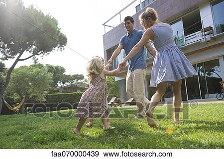 Family playing ring-around-the-rosy outdoors View Large Photo Image Stock Photo - Family playing ring-around-the-rosy outdoors. Fotosearch