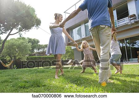 Family playing ring-around-the-rosy outdoors View Large Photo Image Stock Photograph - Family playing ring-around-the-rosy outdoors. Fotosearch