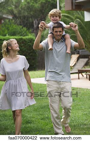 Family walking together outdoors, father carrying son on his shoulders View Large Photo Image Stock Image - Family walking together outdoors, father carrying son on his shoulders. Fotosearch
