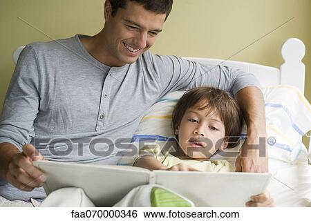 Father and son reading story together View Large Photo Image Stock Photograph - Father and son reading story together. Fotosearch
