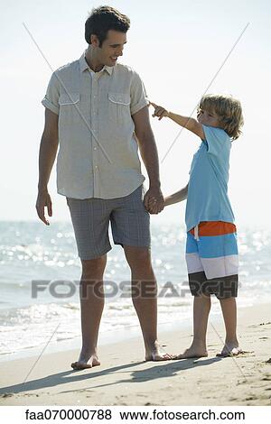 Stock Photo - Father and son spending time together at the beach. Fotosearch