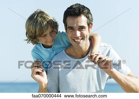 Father and son together outdoors, portrait View Large Photo Image Picture - Father and son together outdoors, portrait. Fotosearch