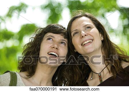 Female friends together outdoors, portrait View Large Photo Image Stock Image - Female friends together outdoors, portrait. Fotosearch