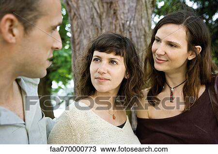 Friends chatting outdoors View Large Photo Image Stock Image - Friends chatting outdoors. Fotosearch