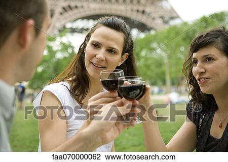 Friends clinking wine glasses outdoors View Large Photo Image Stock Image - Friends clinking wine glasses outdoors. Fotosearch
