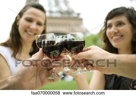 Friends clinking wine glasses outdoors View Large Photo Image Stock Photo - Friends clinking wine glasses outdoors. Fotosearch