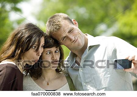 Friends making funny faces for photo View Large Photo Image Stock Photo - Friends making funny faces for photo. Fotosearch