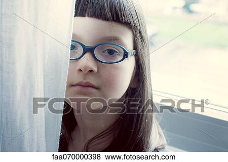 Stock Photo - Girl hiding behind curtain. Fotosearch