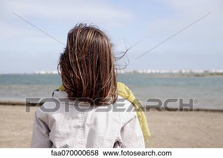 Girl looking at ocean, rear view View Large Photo Image Stock Photo - Girl looking at ocean, rear view. Fotosearch