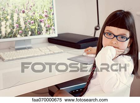 Stock Photography - Girl sitting in front of desktop computer. Fotosearch
