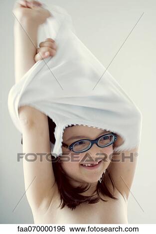 Stock Photograph - Girl taking off clothes. Fotosearch
