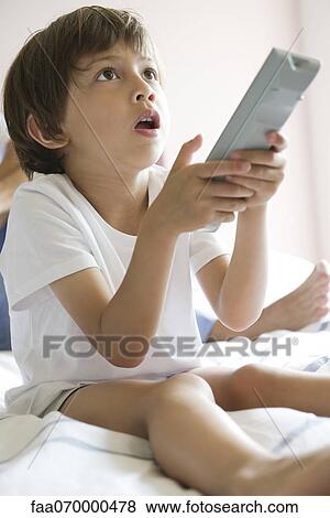 Little boy watching TV View Large Photo Image Stock Photo - Little boy watching TV. Fotosearch