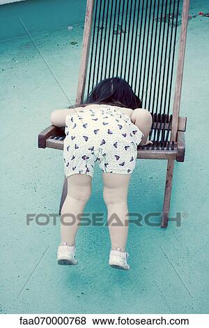 Little girl climbing onto chair, rear view View Large Photo Image Stock Photo - Little girl climbing onto chair, rear view. Fotosearch