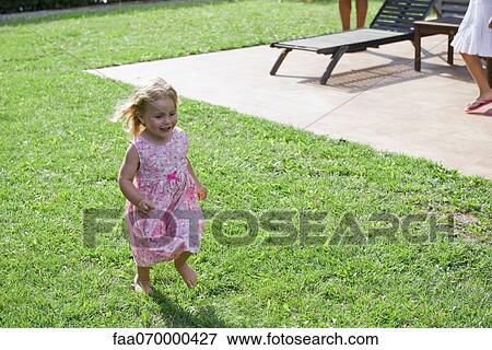 Stock Photo - Little girl having fun outdoors. Fotosearch