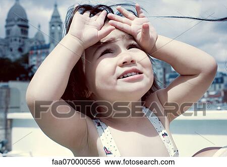Little girl looking up, hands shading eyes View Large Photo Image Stock Photograph - Little girl looking up, hands shading eyes. Fotosearch