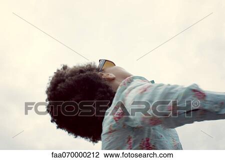 Stock Image - Little girl, low angle view, cropped. Fotosearch