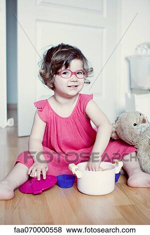 Little girl playing with toy pot View Large Photo Image Stock Photo - Little girl playing with toy pot. Fotosearch