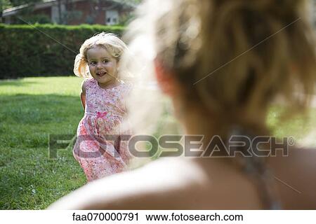 Stock Image - Little girl running toward mother. Fotosearch