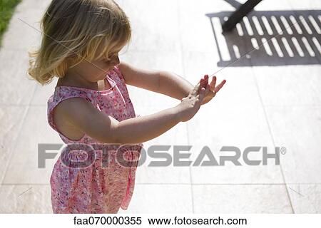 Little girl standing outdoors, comtemplating hands View Large Photo Image Stock Photography - Little girl standing outdoors, comtemplating hands. Fotosearch