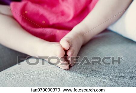 Stock Photo - Little girl's feet, low section. Fotosearch