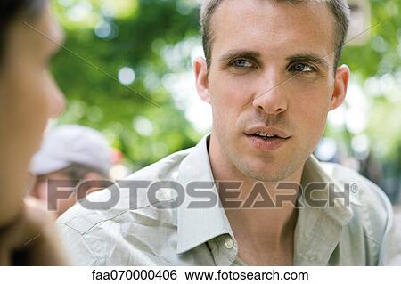 Stock Photograph - Man talking with woman outdoors. Fotosearch