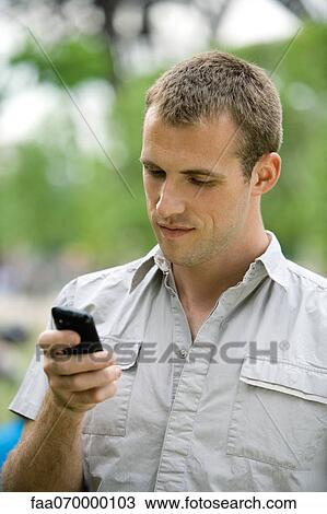 Man text messaging with cell phone View Large Photo Image Stock Image - Man text messaging with cell phone. Fotosearch