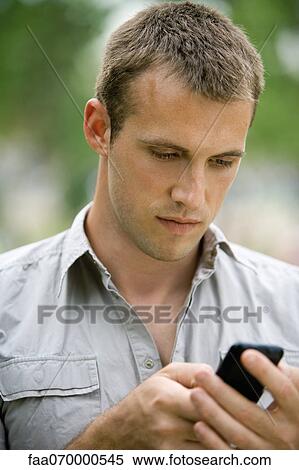 Man text messaging with cell phone View Large Photo Image Stock Photography - Man text messaging with cell phone. Fotosearch