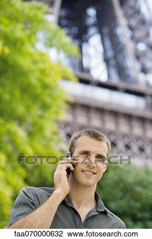 Man using cell phone outdoors View Large Photo Image Stock Image - Man using cell phone outdoors. Fotosearch