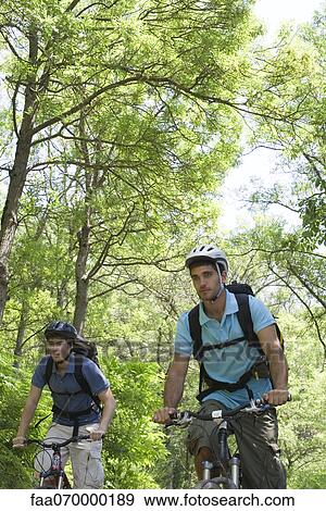 Men riding bicycles in woods View Large Photo Image Stock Photo - Men riding bicycles in woods. Fotosearch