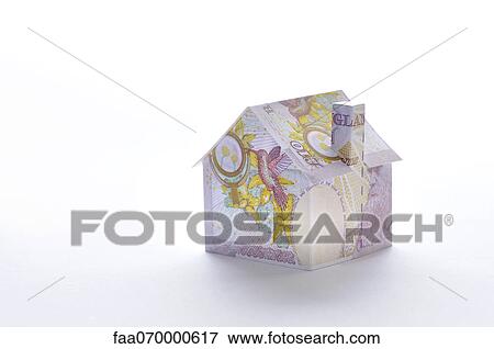 Stock Photo - Model house folded with British pound banknote. Fotosearch