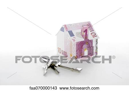 Stock Image - Model house folded with euro banknotes and keys. Fotosearch
