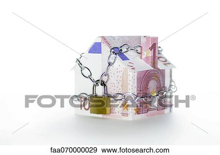 Stock Photo - Model house folded with euro banknotes chained and padlocked. Fotosearch
