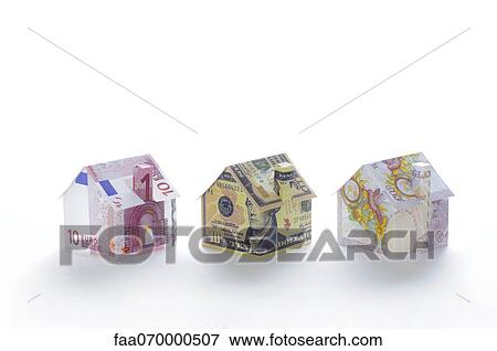 Stock Photo - Model houses folded with different currencies. Fotosearch