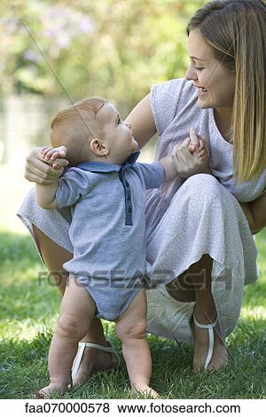 Mother and baby bonding outdoors View Large Photo Image Stock Photo - Mother and baby bonding outdoors. Fotosearch