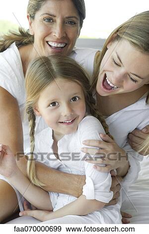 Stock Photo - Mother and daughters, portrait. Fotosearch