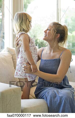 Mother and young daughter talking on sofa View Large Photo Image Stock Photo - Mother and young daughter talking on sofa. Fotosearch