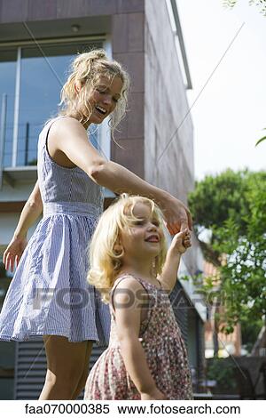 Mother and young daughter walking hand-in-hand outdoors View Large Photo Image Stock Photography - Mother and young daughter walking hand-in-hand outdoors. Fotosearch